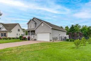 a large white house with a garage at 4 Mi to Bethany Beach Frankford Getaway with Pool! in Frankford
