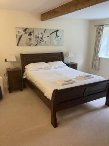 a bedroom with a bed with two towels on it at Lake Cottage , Middleton Hall Estate in Belford