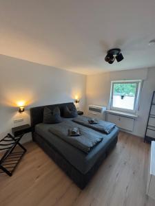 a bedroom with a large bed and a window at Direkt am See Winterberg Elkeringhausen in Winterberg