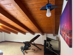 a room with a chair and a flat screen tv at Messina Skyline in Messina