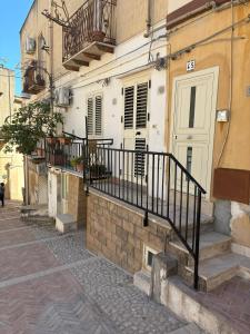 a building with a staircase next to a building at Appartamento centro storico quartiere San Michele in Sciacca