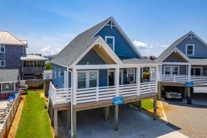 a blue and white house with a porch at NH387B Ocracoke Cottage in Nags Head