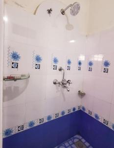 巴拉特布尔Ojas Home Bharatpur - 奥贾斯之家巴拉特普尔的带淋浴的浴室，铺有蓝白瓷砖 更多23张照片