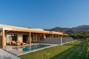 a villa with a swimming pool and a house at Lakka Suites in Malia