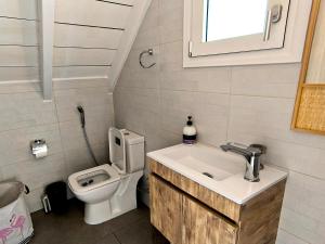 a bathroom with a sink and a toilet at Seaside Glow in Schinias +28 photos