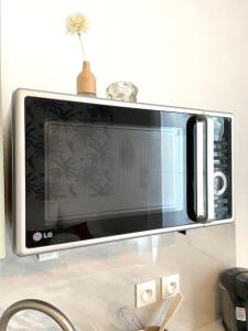 a microwave oven sitting on top of a counter at Studio 10min Paris Centre I CDG in Drancy