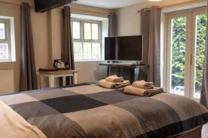 a bedroom with a bed with towels on it at The Mill Bed and Breakfast in Stone