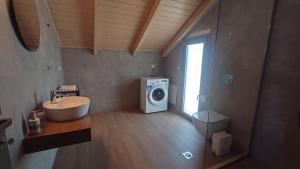 a bathroom with a washing machine and a sink at Ionian Moon 2 in Preveza +4 photos