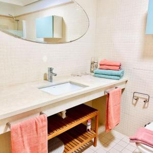 a bathroom with a sink and a mirror at Sea Paradise - Balcon de los Gigantes in Puerto de Santiago
