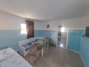a room with a bed and a table in it at Dar Kamel in El Haouaria