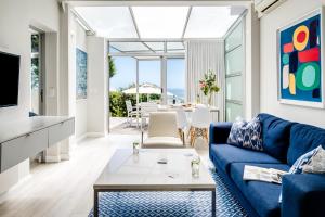 a living room with a blue couch and a table at Sea Escape in Cape Town