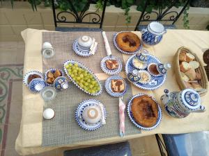 a table with blue and white plates of food on it at Dar Nour in Sousse +14 photos