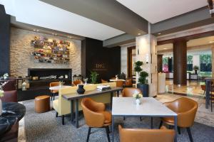 a lobby with tables and chairs and a fireplace at InterContinental New York Times Square by IHG in New York +37 photos