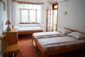 En eller flere senge i et værelse på Guest House Barbov