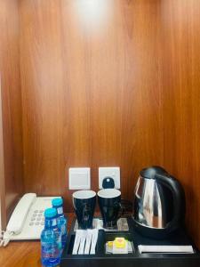 a kitchen counter with a coffee maker and a telephone at فندق غالية احد in Al Madinah