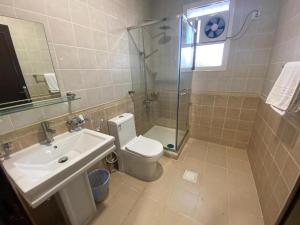 a bathroom with a toilet and a sink and a shower at فندق غالية احد in Al Madinah