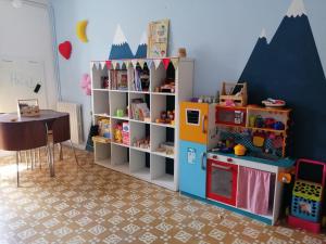 a play room with a toy refrigerator and a table at Apartament Bellserrat in Sant Pere de Torelló