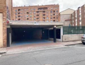 a parking garage with a building in the background at Entre Algodones in Logroño