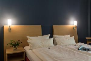 Postel nebo postele na pokoji v ubytování Hotel Mainpromenade ***S