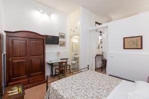 a bedroom with a bed and a wooden door at Casa Ariadne by Ortigia Apartments in Syracuse