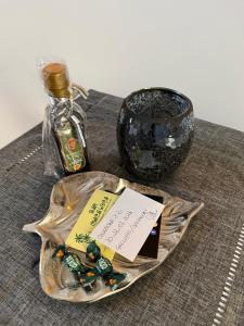 a plate with a bottle of whiskey and a glass container at Il Cuore di Trapani in Trapani