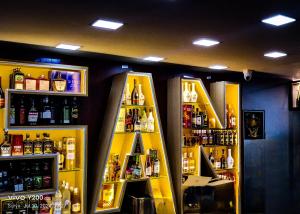 a store with a shelf with bottles of alcohol at SAN BEACH RESIDENCY in Karaikal