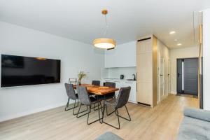a kitchen and dining room with a table and chairs at J7 Beržas 7A-1 in Palanga