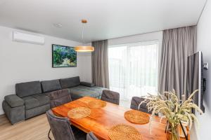a living room with a table and a couch at J7 Beržas 7A-1 in Palanga