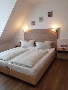 Postel nebo postele na pokoji v ubytování Hotel Mühleneck