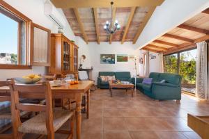 a kitchen and living room with a table and chairs at Hermosa Finca Padre in Son Servera