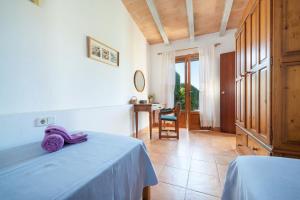 a bedroom with a bed with a purple towel on it at Hermosa Finca Padre in Son Servera +28 photos