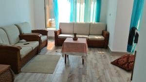 a living room with two couches and a table at New venisia Resort in Ain Sokhna