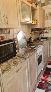 a kitchen with white cabinets and a stove top oven at New venisia Resort in Ain Sokhna +7 photos