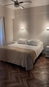 a bedroom with a bed with a ceiling fan at Departamento Plaza Colón Yeyita in Mar del Plata