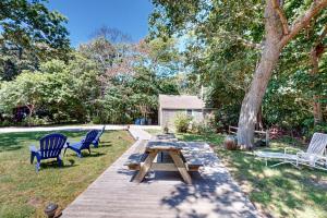 a picnic table with two chairs and a tree at Coastal Retreat in Centerville