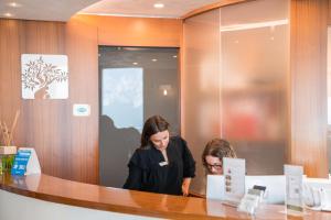 two women standing at a counter in a store at Garda Hotel Forte Charme in Nago-Torbole