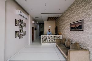 a man standing at a counter in a room at Hotel Fortune Plaza in Ajmer