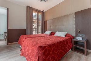 Ein Bett oder Betten in einem Zimmer der Unterkunft Hotel de La Trucha