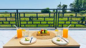 a table with plates of fruit and glasses of orange juice at Atavillaaa in Samsun