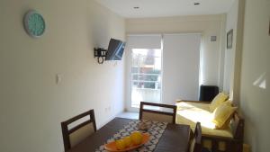 a dining room with a table with fruit on it at Departamento nuevo en San Bernardo in San Bernardo