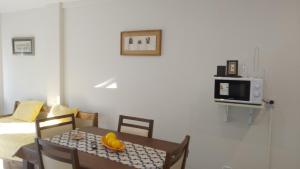 a dining room with a table and a microwave at Departamento nuevo en San Bernardo in San Bernardo +9 photos
