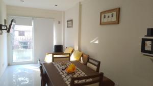 a dining room with a table and chairs and a room at Departamento nuevo en San Bernardo in San Bernardo