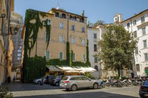 a large building with cars parked in a parking lot at The Right Place 4U Quercia Apartment in Rome