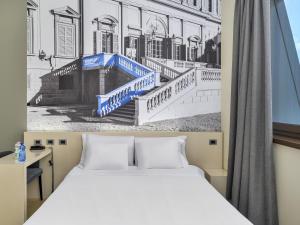 A bed or beds in a room at B&B Hotel Milano-Monza