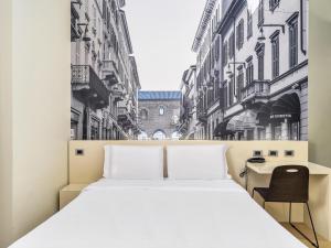 A bed or beds in a room at B&B Hotel Milano-Monza