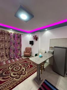 a living room with a table and a couch at فيلا 39 in Dahab