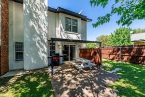 a backyard with a picnic table in front of a house at Country Happiness in Richardson +10 photos