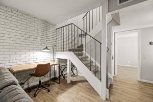 a living room with a staircase and a table and a desk at Country Happiness in Richardson