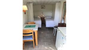 a small room with two beds and a table at Strandnära Stuga Anna in Visby