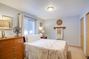 a bedroom with a bed with a dresser and a window at Cave Bay Vacation Rental with Game Room! in Worley